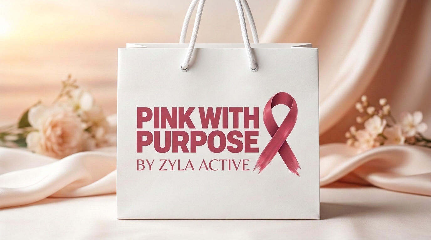 The limited-edition Pink With Purpose goodie bag — a white gift bag with rose ribbon print on soft blush satin